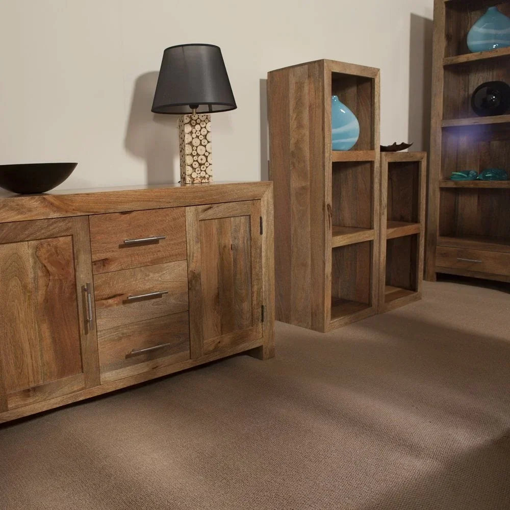 Solid wood sideboard with drawers beside tall wooden shelving units in living room