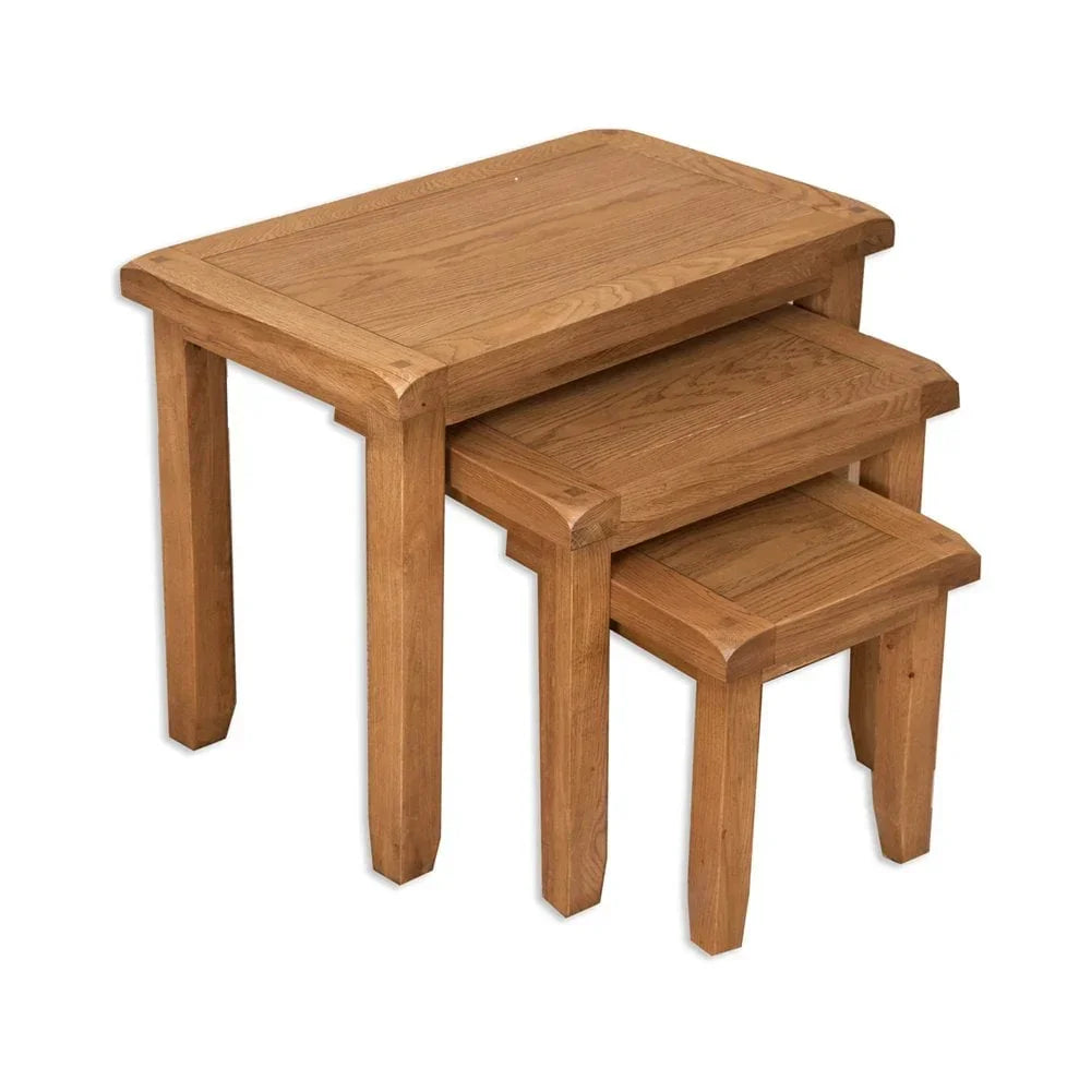 Oak nest of tables set with three rectangular wooden tables stacked together