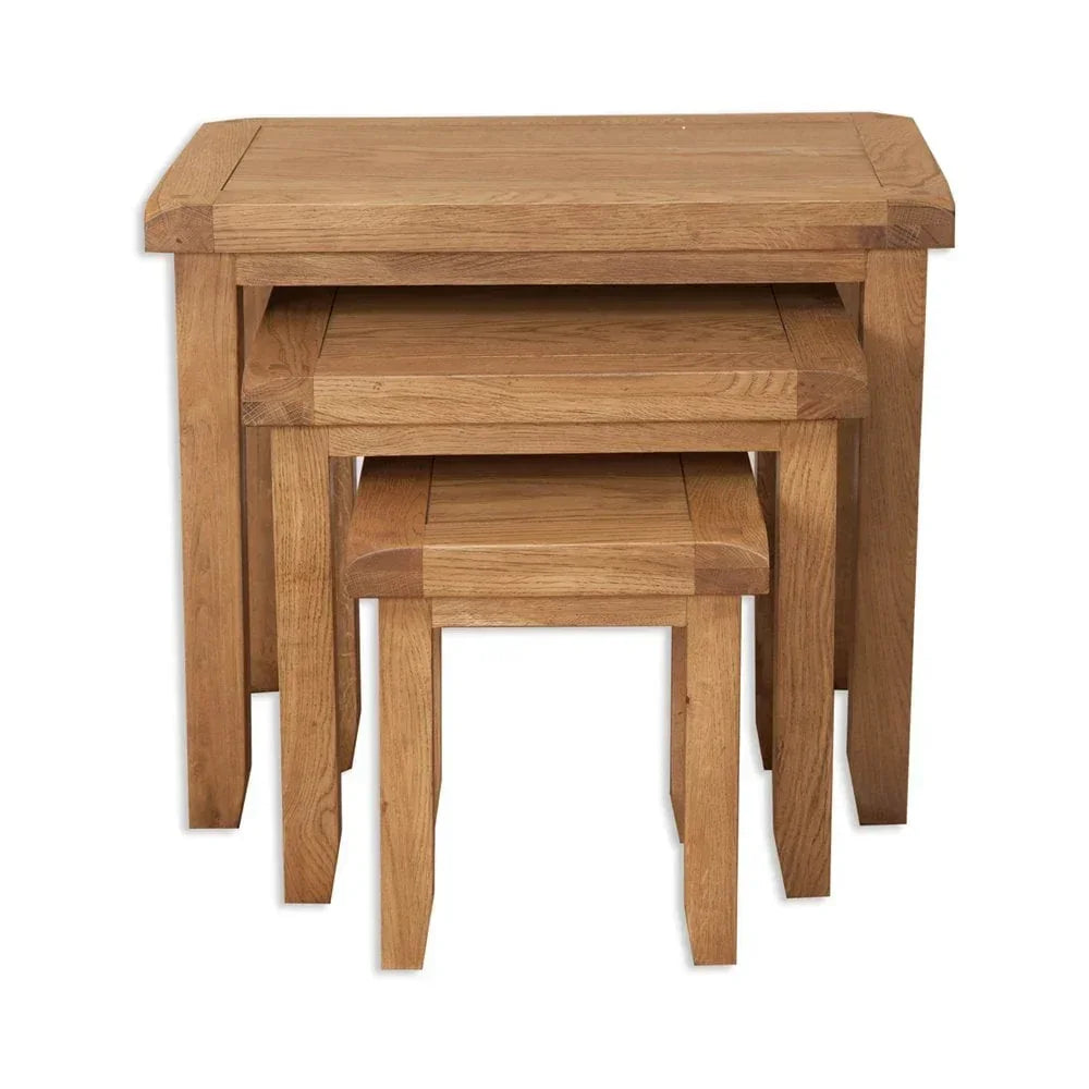 nest of tables in natural oak finish with three sizes stacked together
