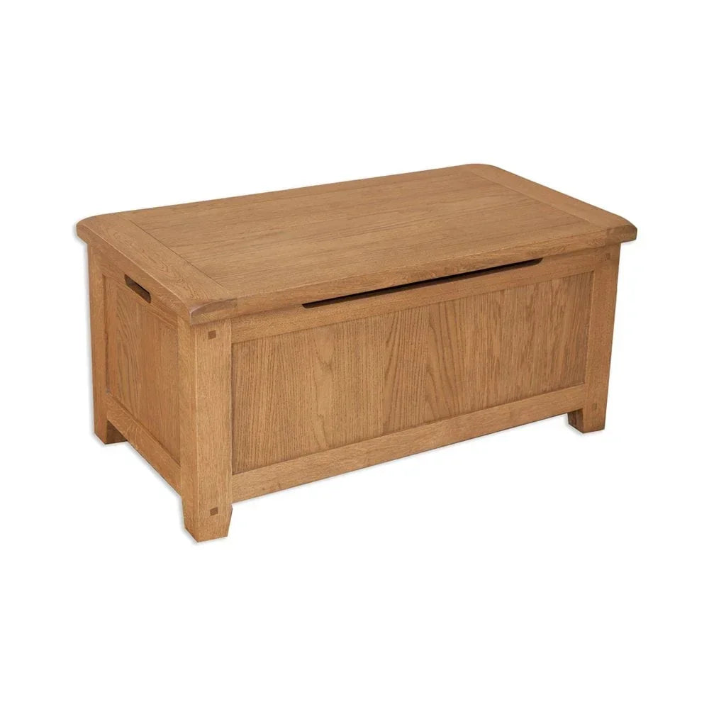 Oak blanket box with panelled front and cut-out handles on sides