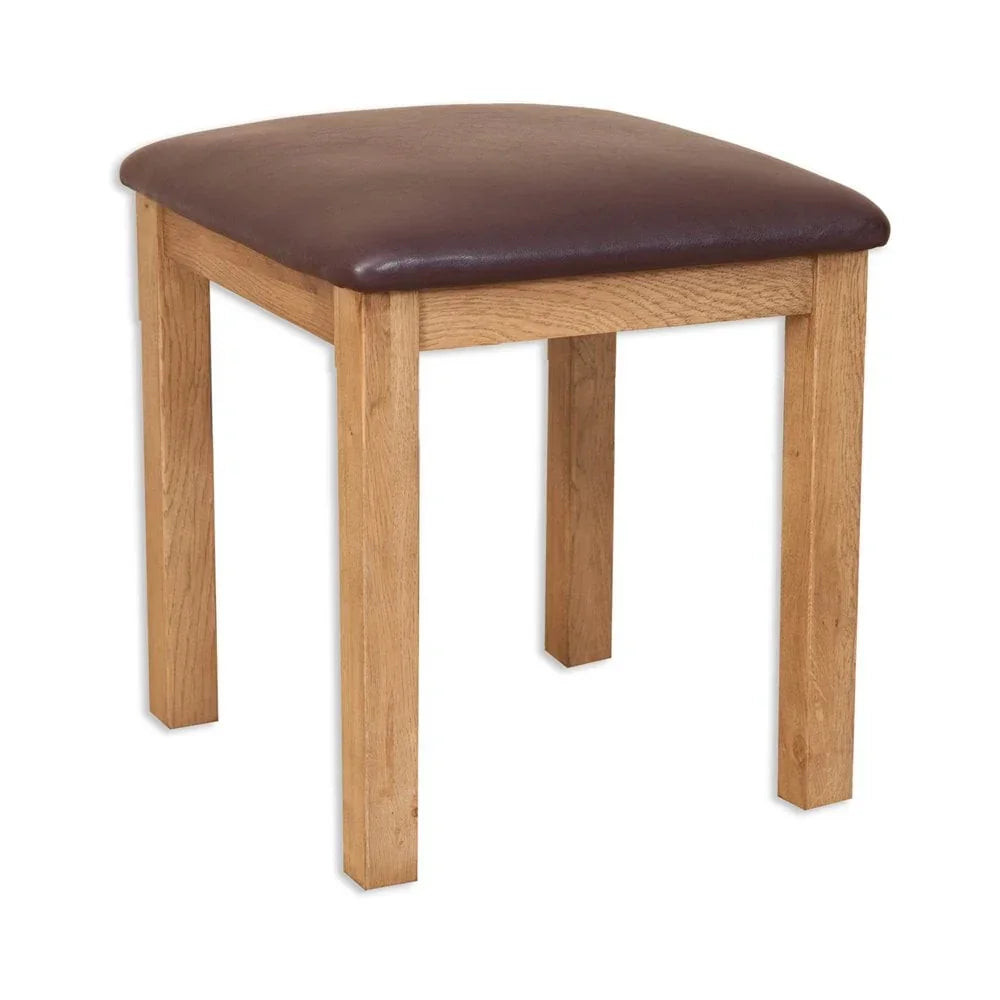 Oak wooden stool with dark brown padded seat, straight legs, shown at angle