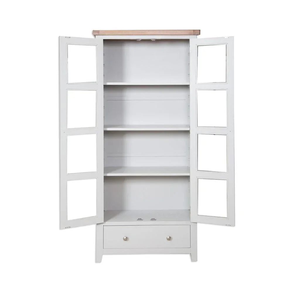 White wooden display cabinet with glass doors, three shelves, and a lower drawer