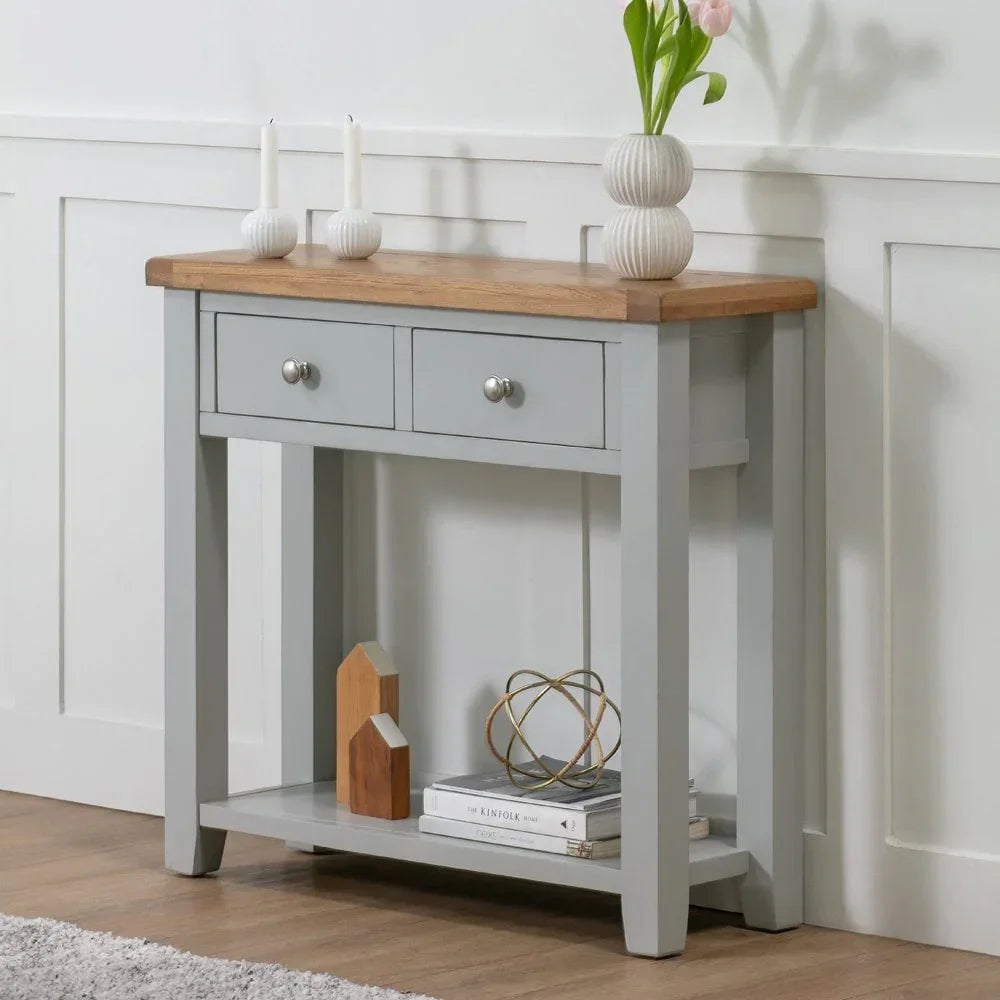 Grey console table with oak top, two drawers, lower shelf, and decorative accents