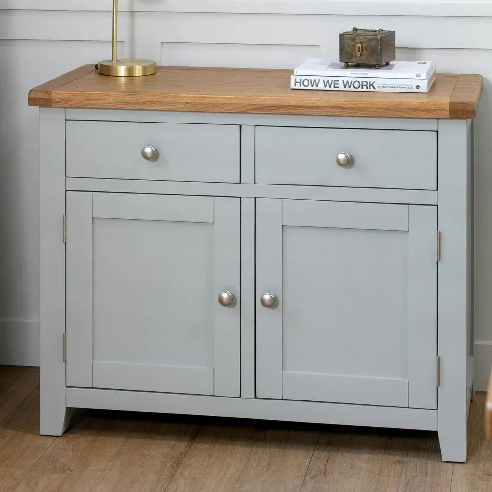 Grey sideboard with oak top, two drawers and two door storage, against a white wall
