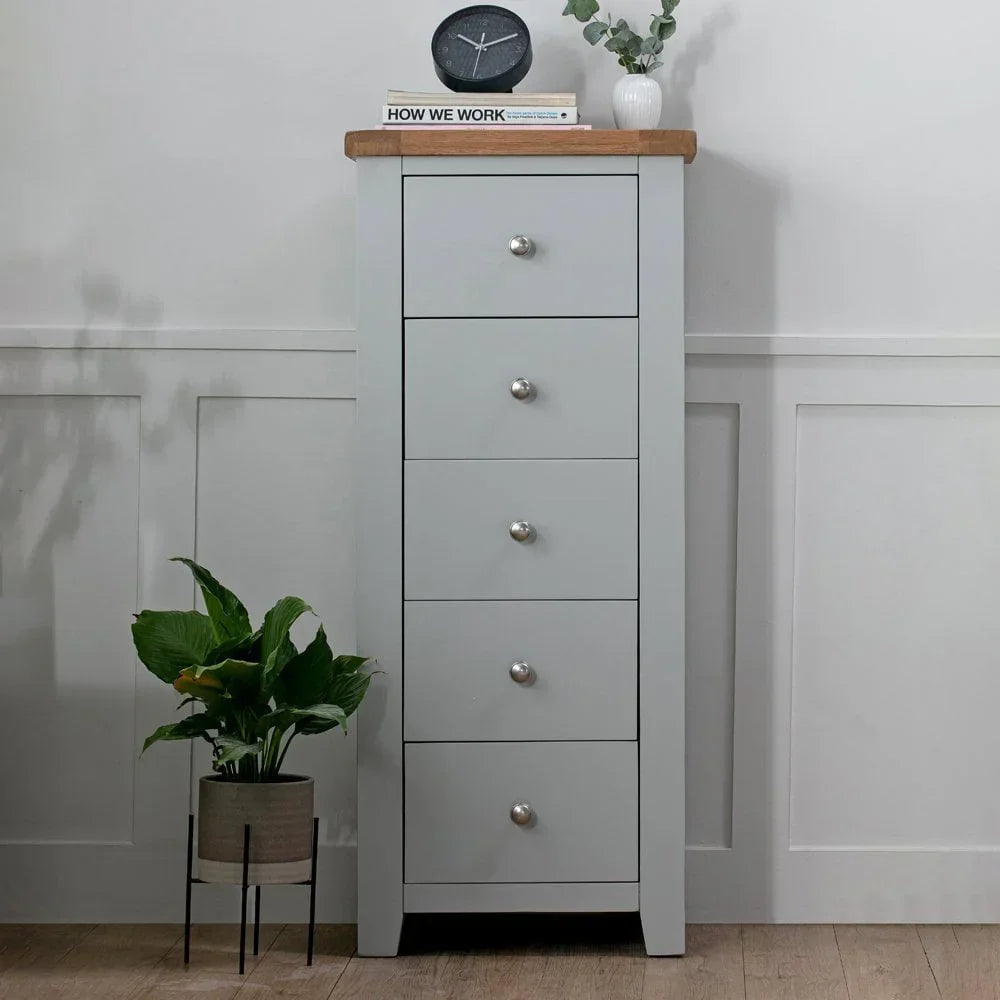 Grey tallboy chest of drawers with oak top and metal knobs in modern room setting