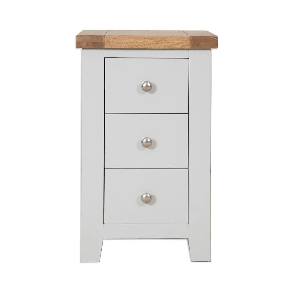 White bedside table with three drawers and oak top, front view