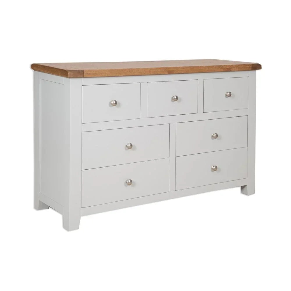 White wooden chest of drawers with oak top and silver handles, front angle view