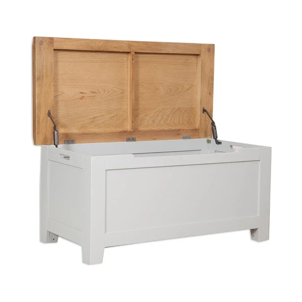 White storage chest with open oak lid and panelled sides, angled front view