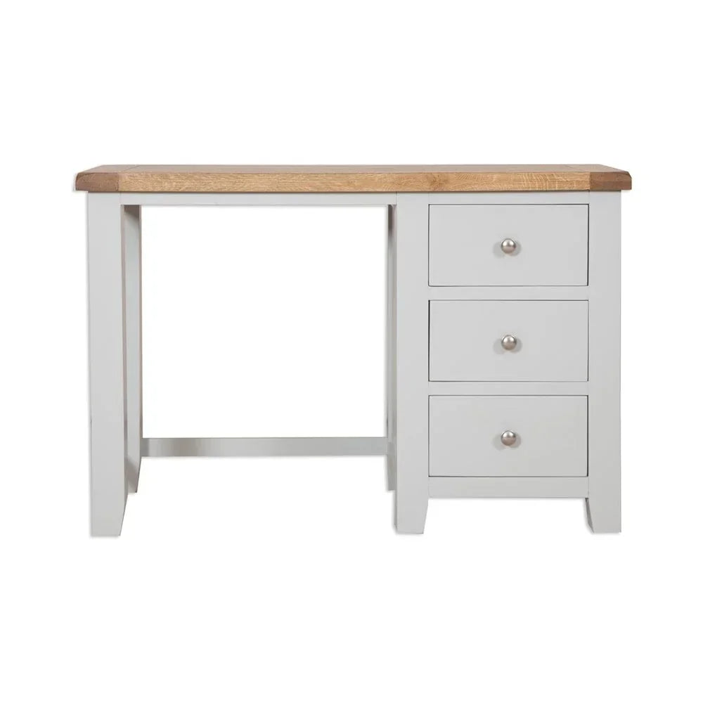 Oak top desk with three white drawers and metal knobs, front view