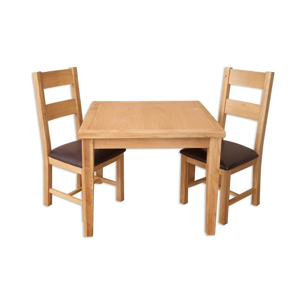Oak dining table set with two matching chairs and brown seat pads
