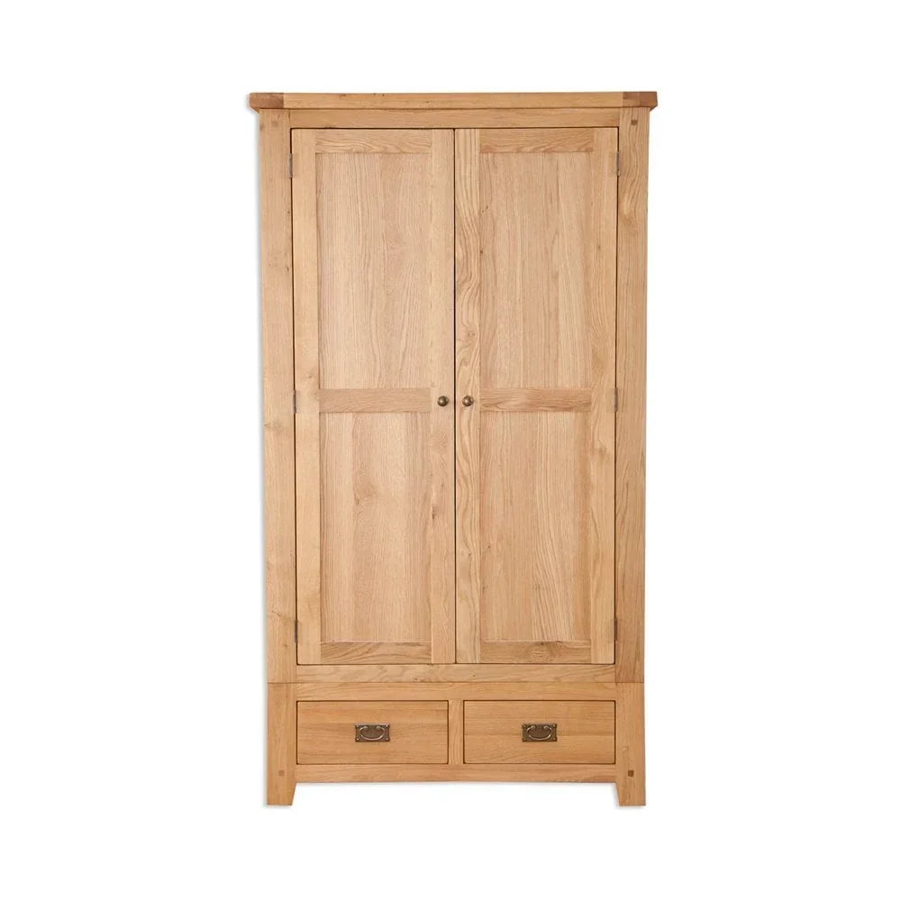 Oak wardrobe with two doors and two bottom drawers, brass handles, on white background