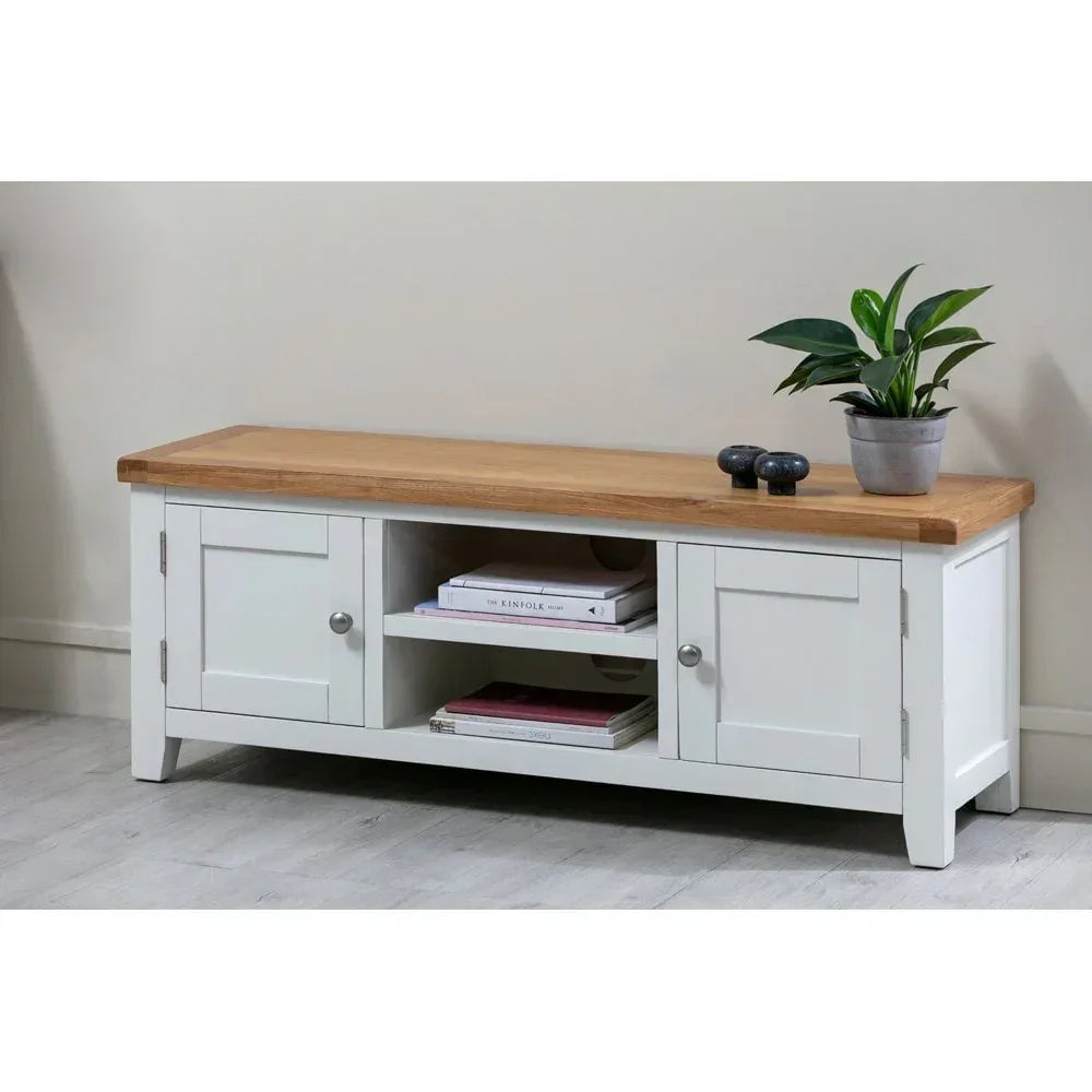 White and oak TV unit with two cabinets, open shelves, and decorative plant on top