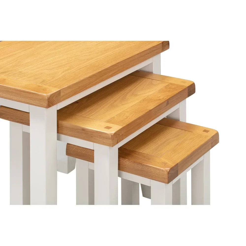 Oak and white nesting tables set showing close-up of tops and legs