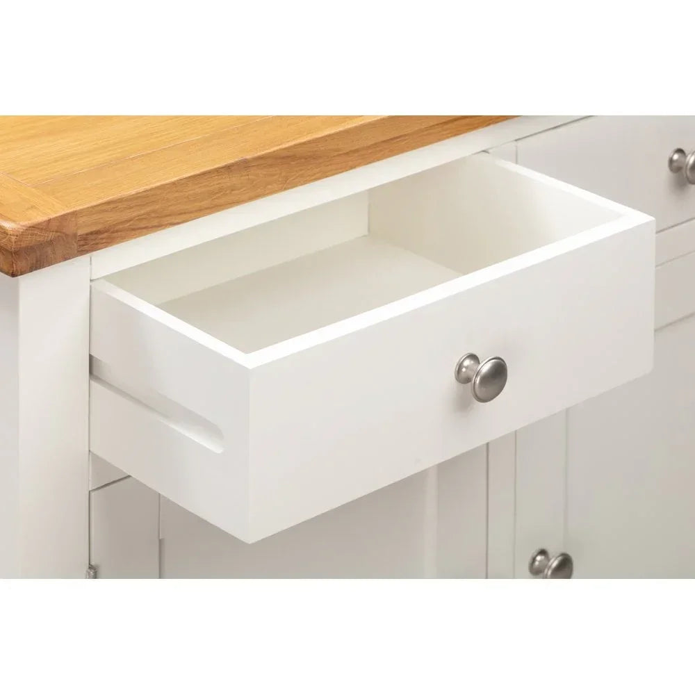 White wooden sideboard drawer with metal knob and oak top, shown open
