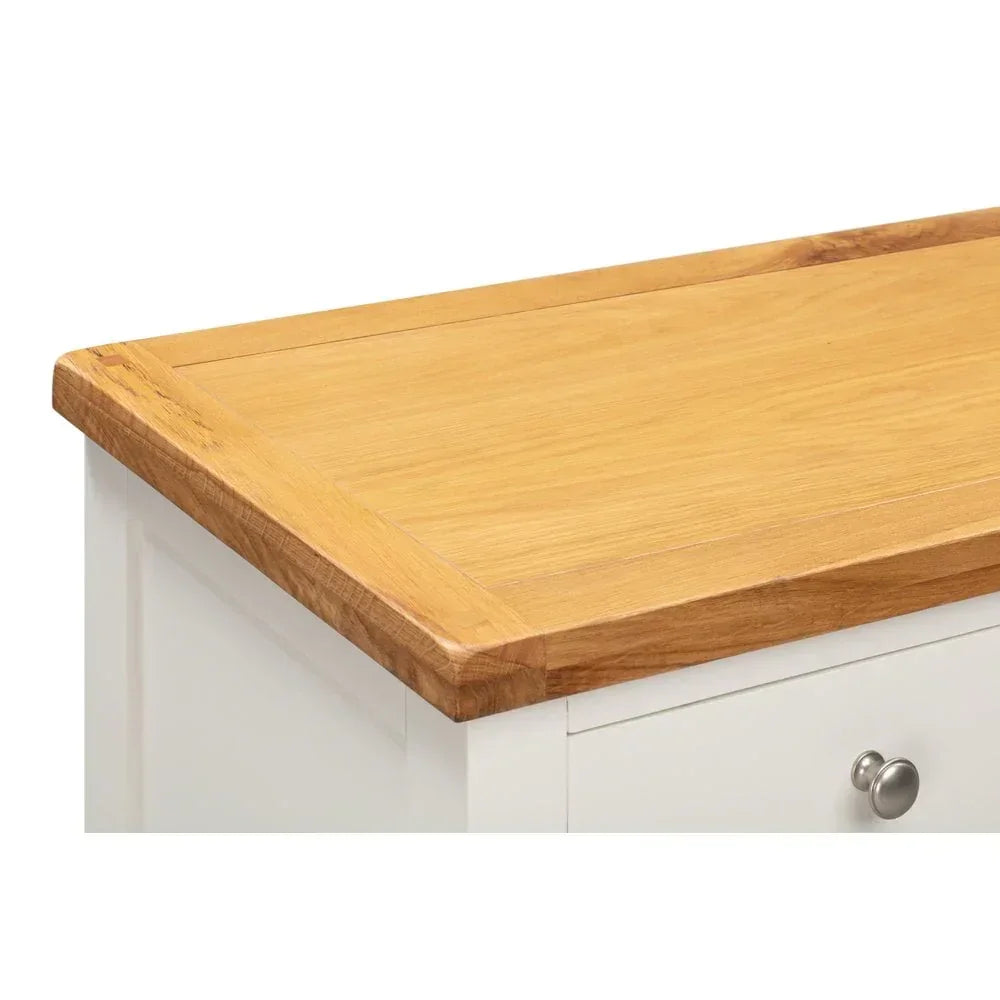 Oak top sideboard with white panel and metal drawer knob, corner angle view