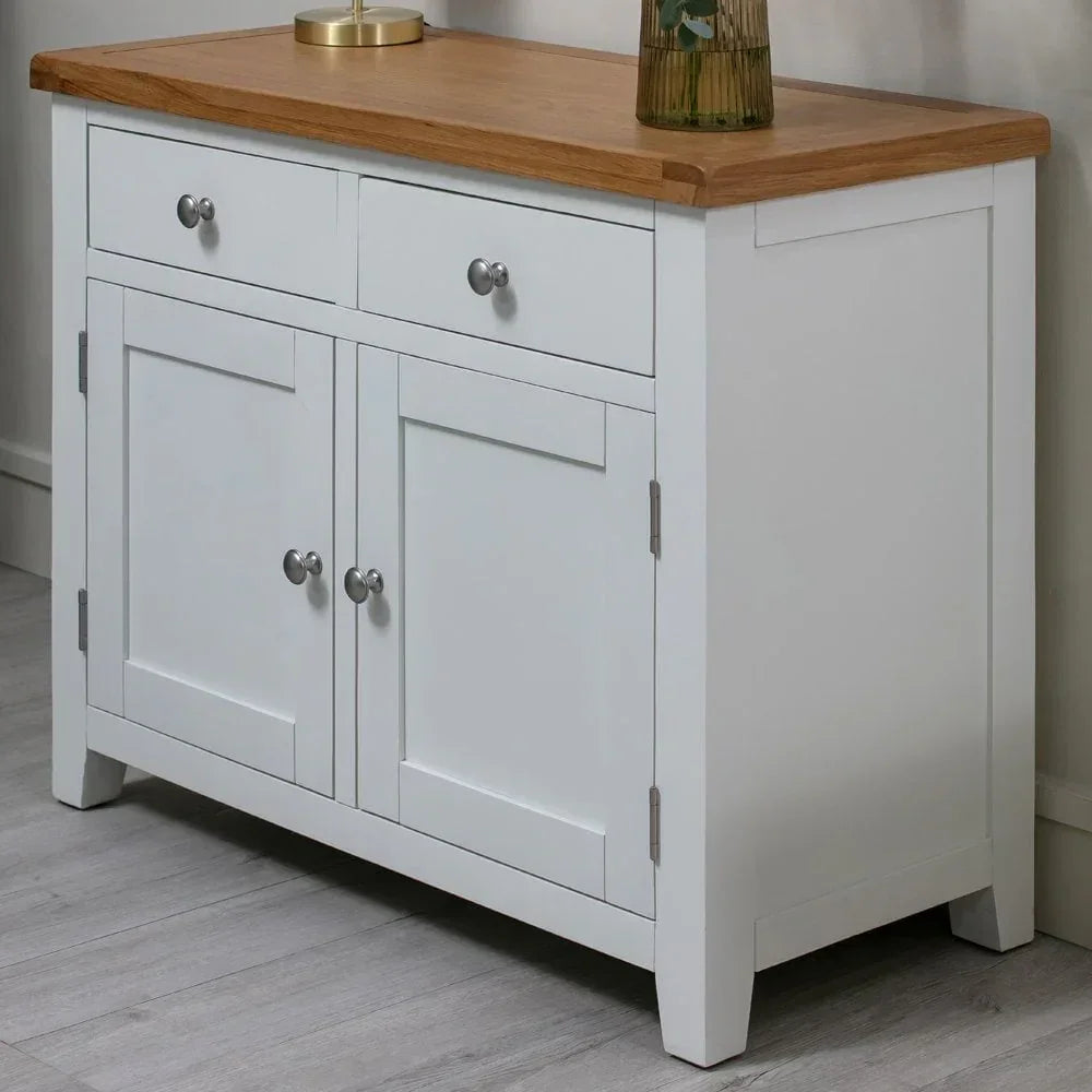 White sideboard with oak top, two drawers and double cupboard on wood floor