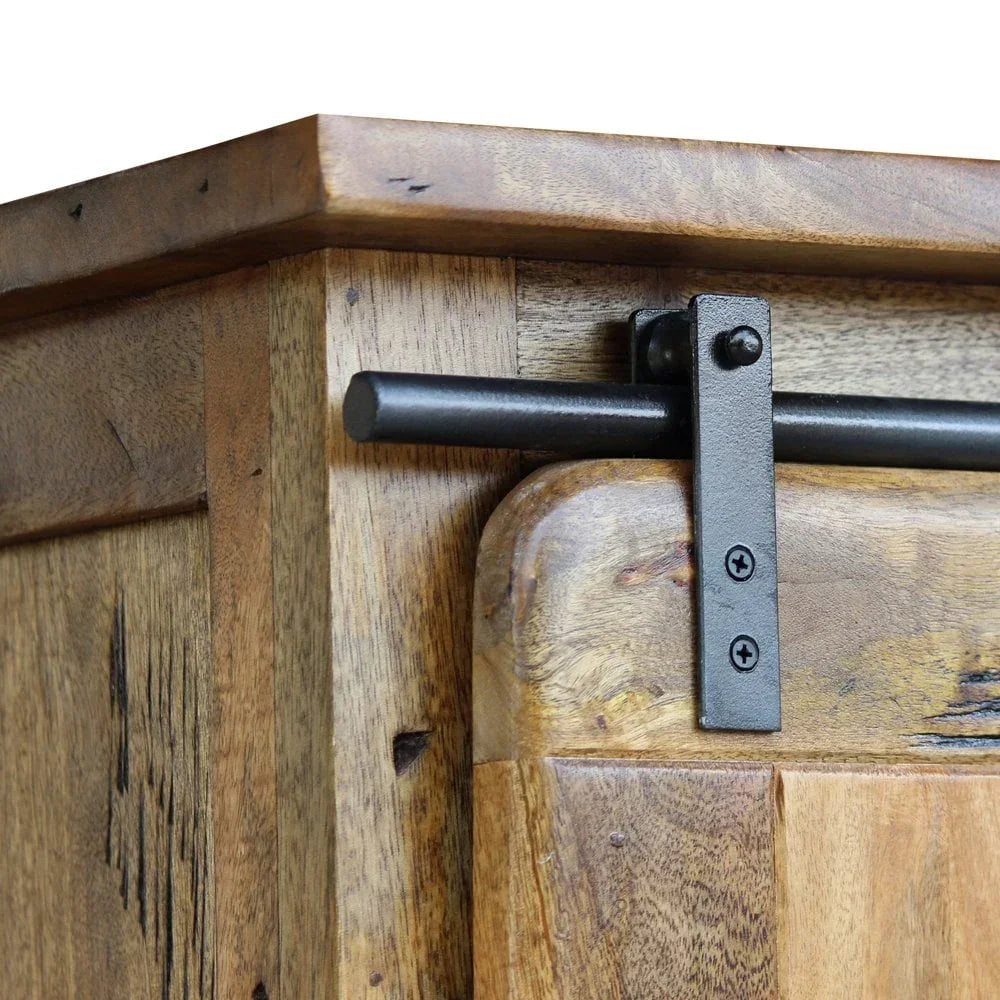 Rustic wood cabinet corner with black metal sliding barn door track and natural grain finish