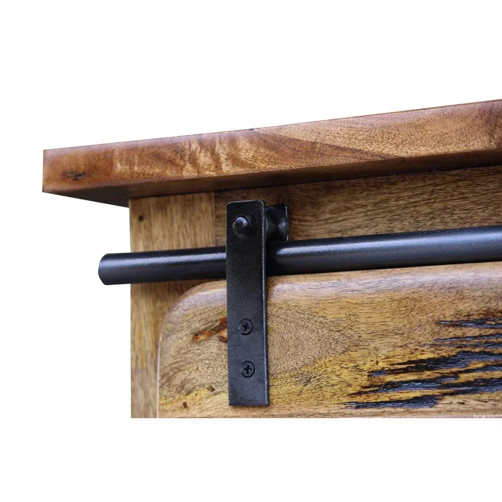 Close up of rustic wooden furniture door with black metal sliding barn door hardware