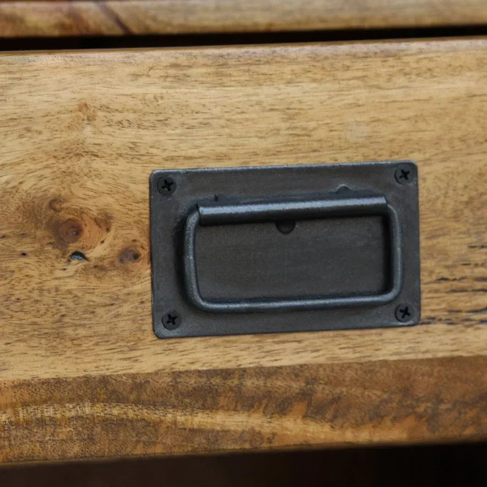 Closeup of black metal drawer handle on natural wood furniture front