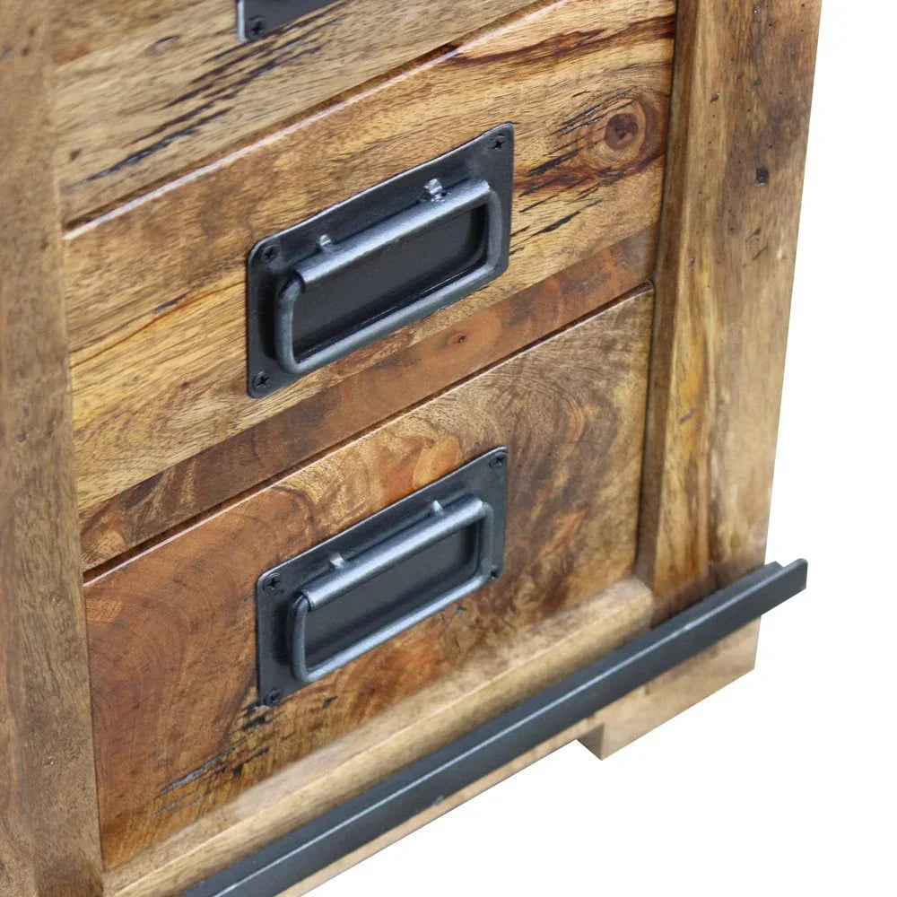 Close-up of wooden chest of drawers with black metal handles and natural wood grain