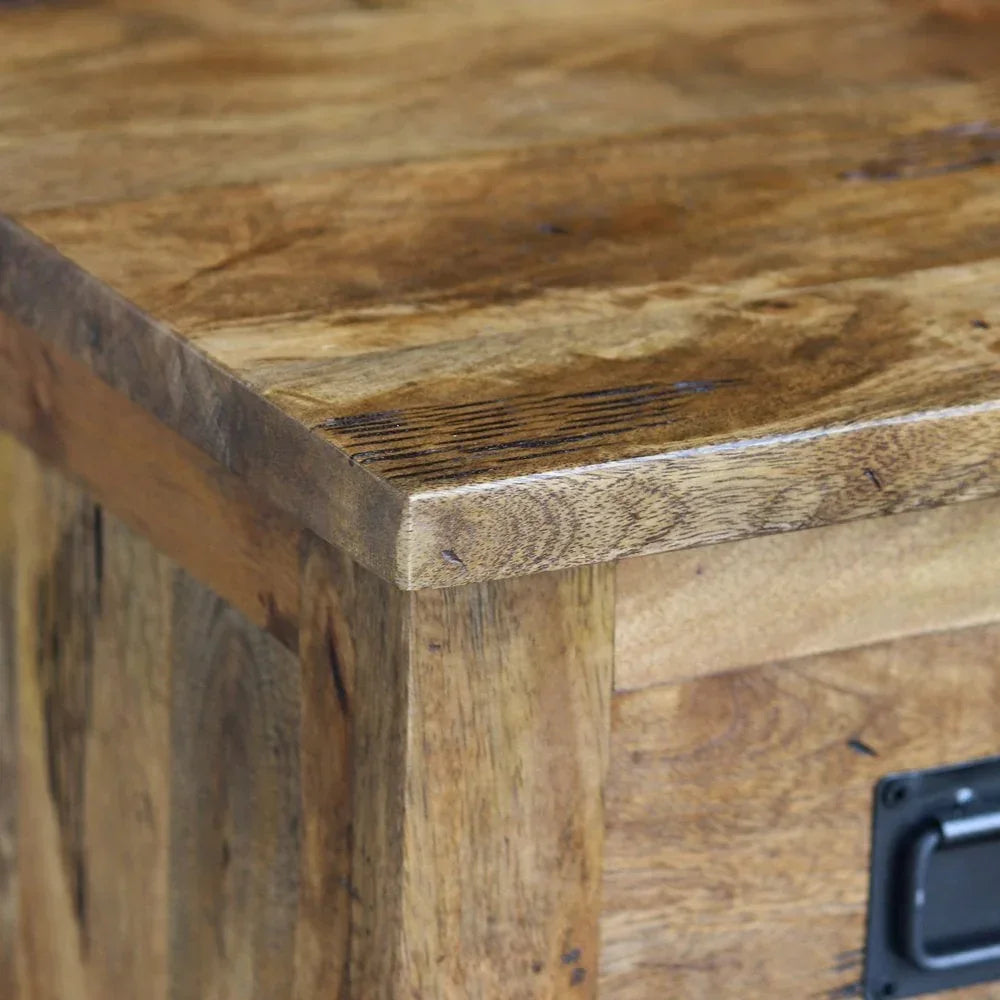 Corner view of solid wood storage chest with visible wood grain and metal handle detail