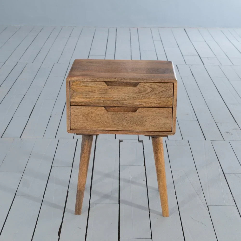 Mid century wooden bedside table with two drawers and angled legs on grey floor