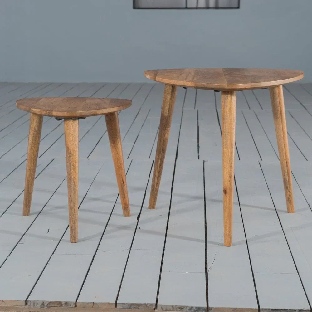 Set of two wooden side tables with tripod legs on painted wood floor
