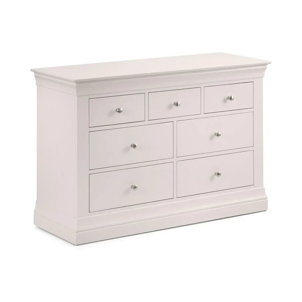 White chest of drawers with seven drawers and silver handles, angled front view
