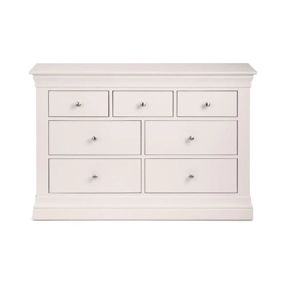 White wooden chest of drawers with seven drawers and chrome handles, front view