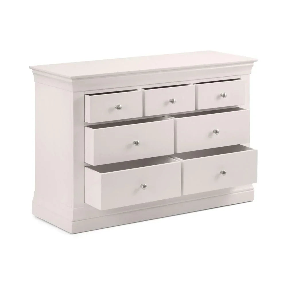 White chest of drawers with seven open drawers and chrome handles, side angle view
