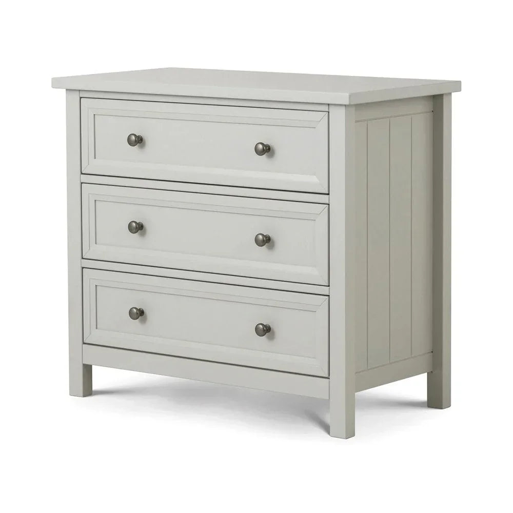 Light grey wooden chest of drawers with three drawers and metal knobs, angled view