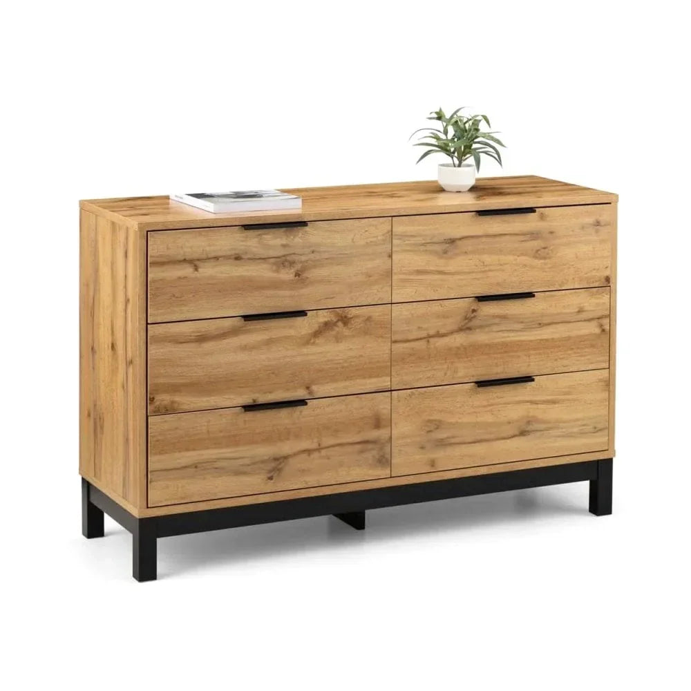 Oak wood chest of drawers with six black handles and black metal legs, plant and book on top