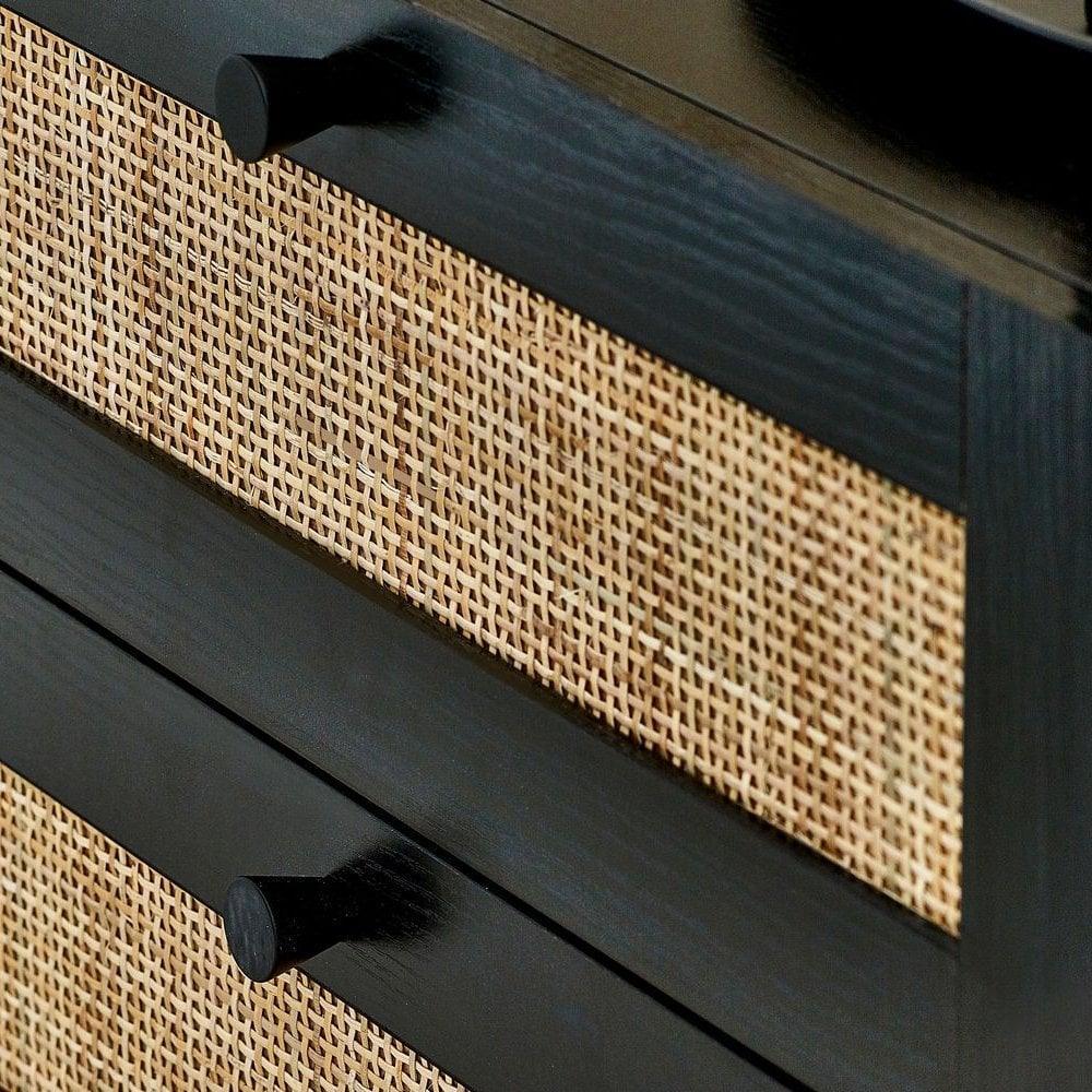 Black wood drawer with woven rattan front and matte black handles close up
