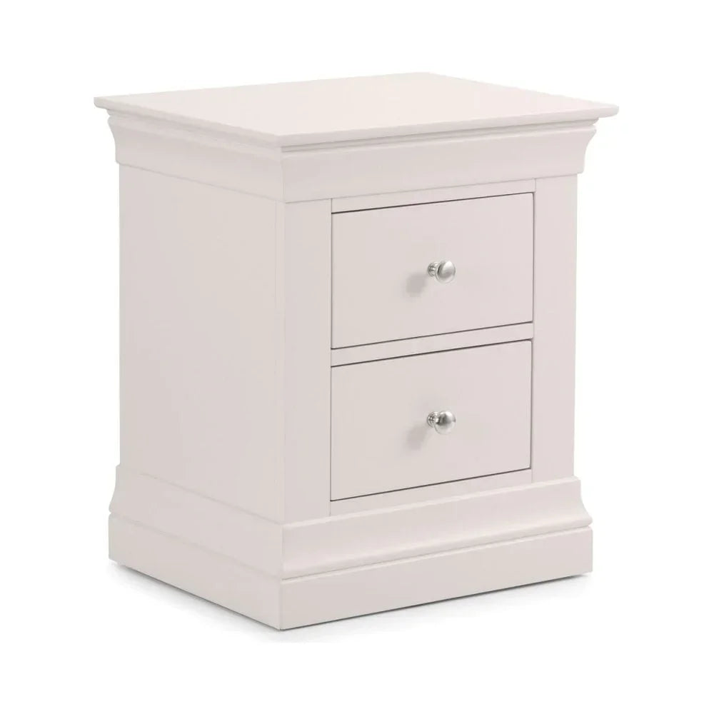 White bedside table with two drawers and chrome handles, angled front view