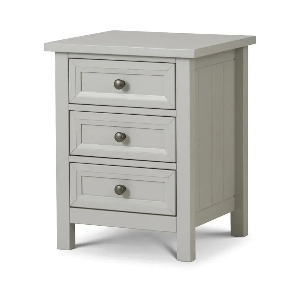 Grey bedside table with three drawers and metal handles, angled front view