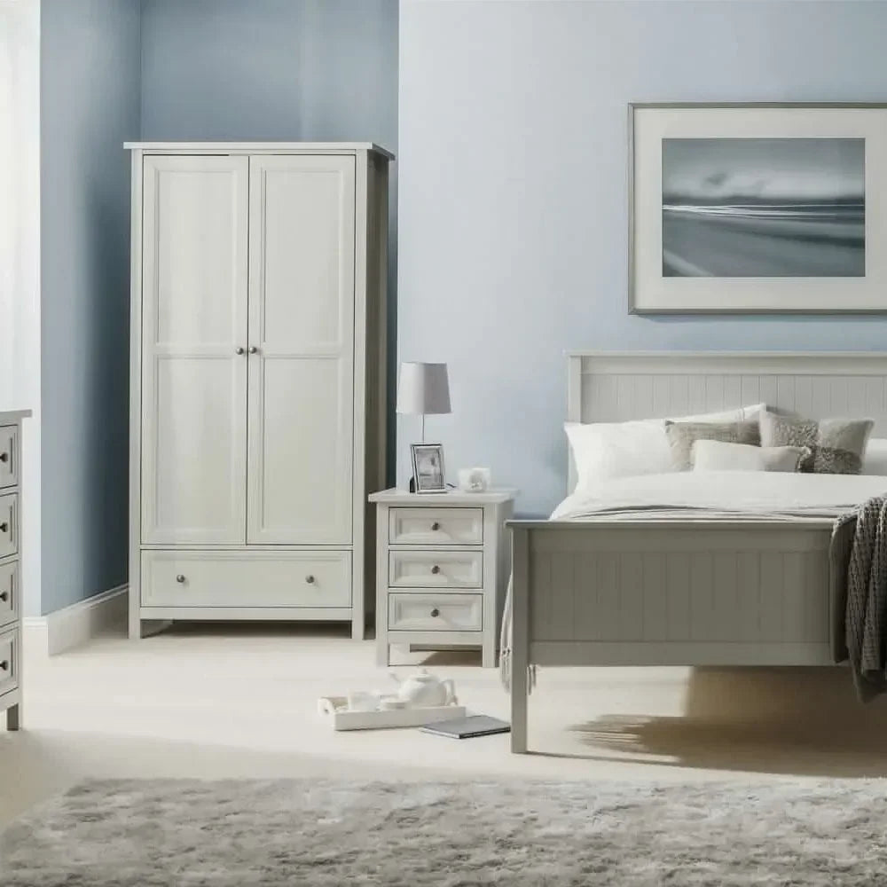 Grey bedroom furniture set with wardrobe, bedside table, and bed on cream carpet