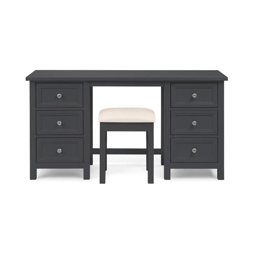 Black dressing table with six drawers and cream cushioned stool on white background