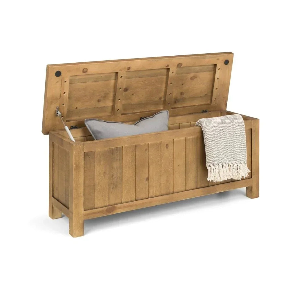 Wooden storage bench with open lid, grey cushion and throw, front angled view