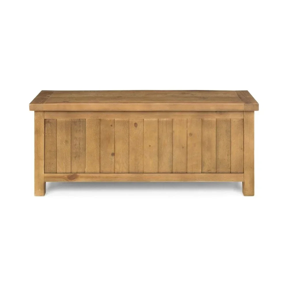 Solid wood storage chest with panelled front and natural finish, front view