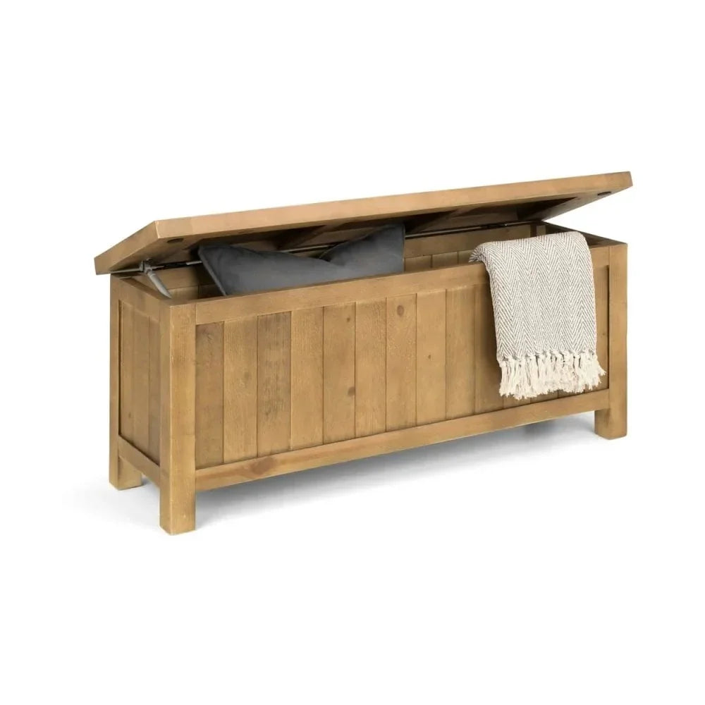 Wooden storage bench with lift-up lid, grey cushion, and patterned throw blanket