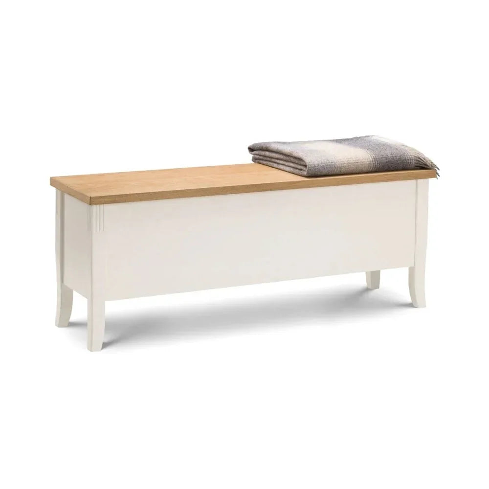 White wooden blanket box with oak top and folded throw placed on lid