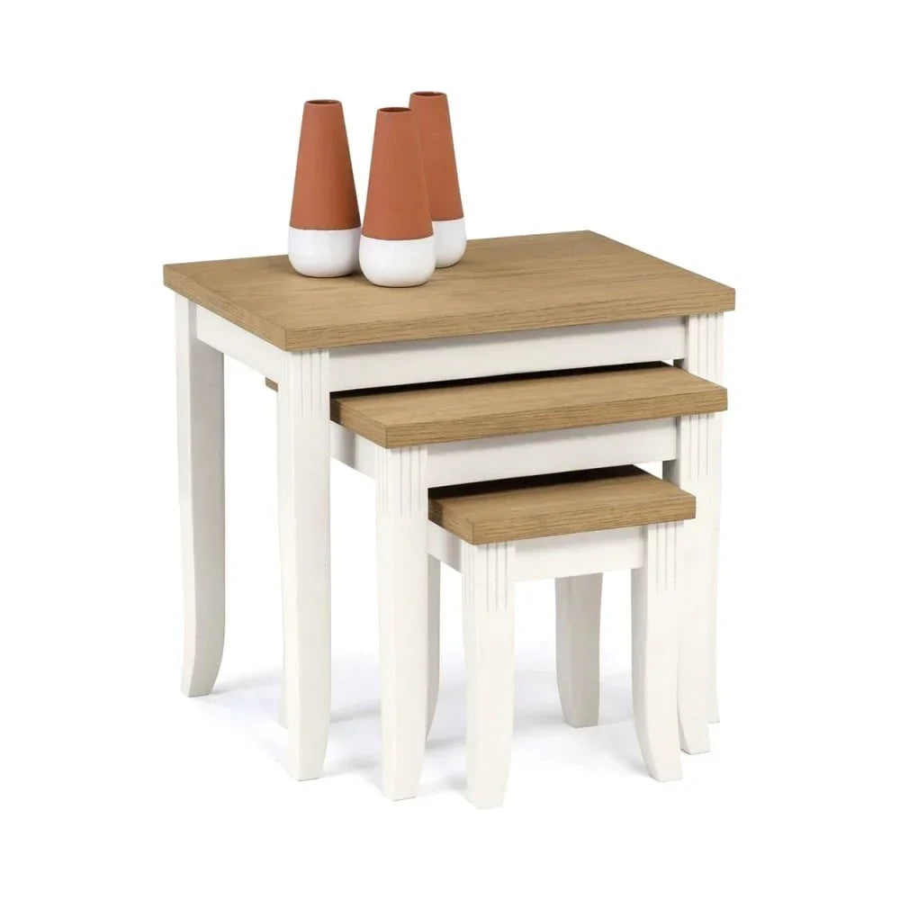 Nest of three white and oak side tables with vases stacked on top