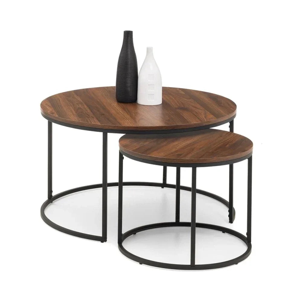 Nest of two round walnut coffee tables with black metal frames and decorative vases