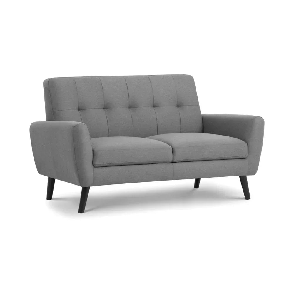Grey fabric sofa with button-tufted backrest and angled wooden legs on white background