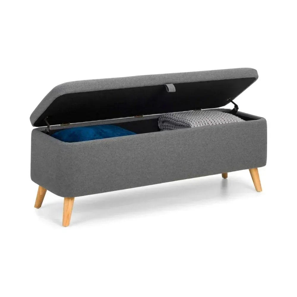 Grey upholstered storage bench with wooden legs, open lid showing blanket and cushion inside