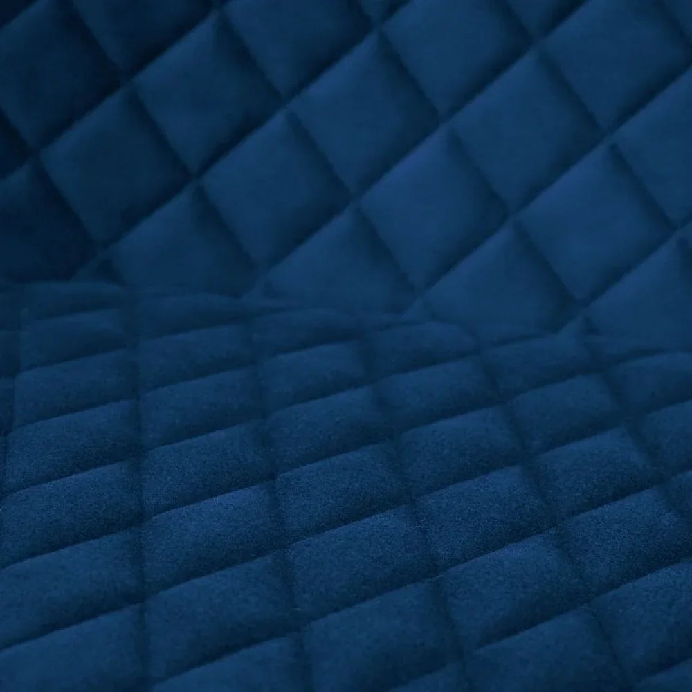 Quilted blue velvet upholstery fabric with diamond stitch detail