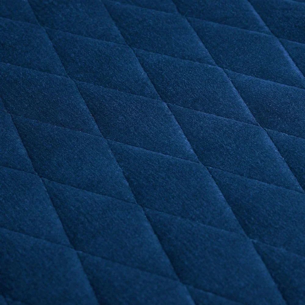Navy blue quilted fabric upholstery with diamond pattern detail