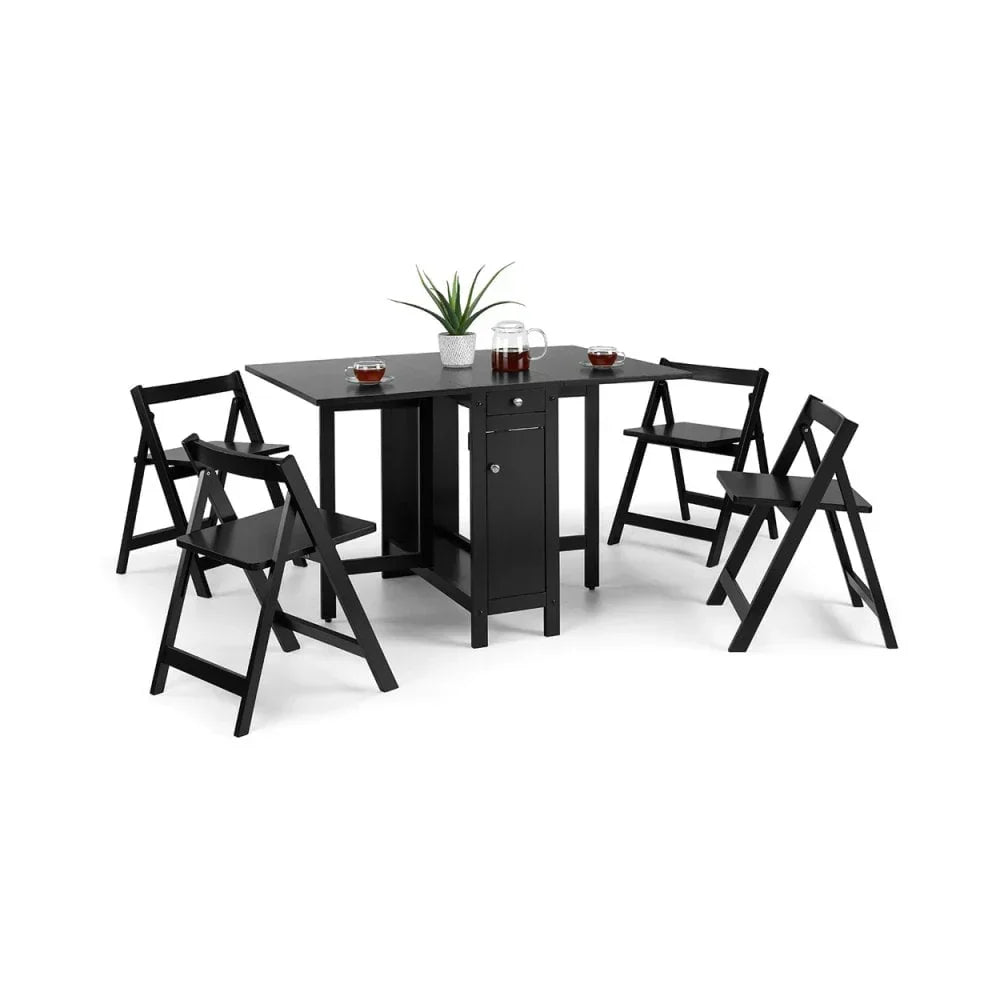 Black folding dining table set with four matching chairs and tabletop decor