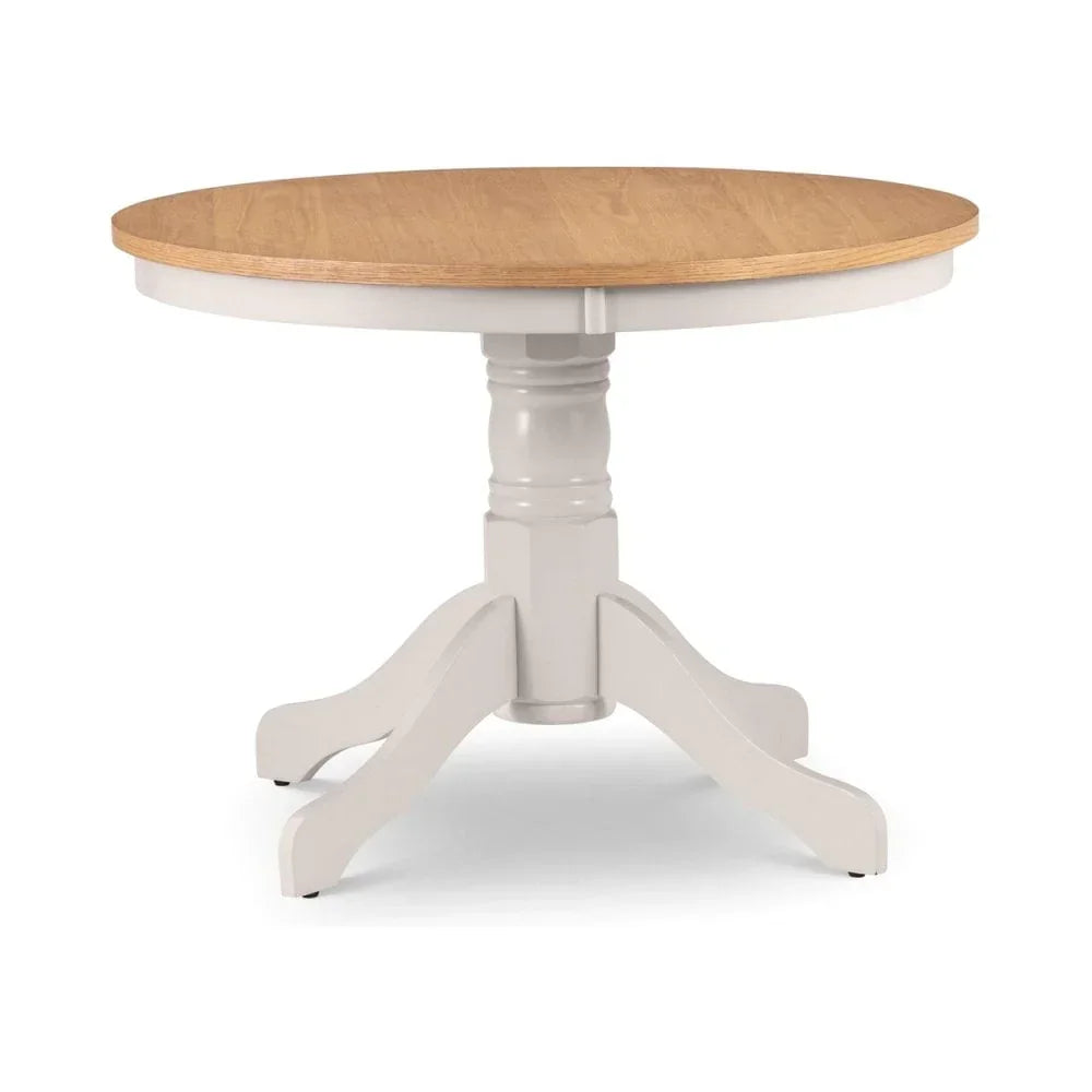Round wooden dining table with natural oak top and white pedestal base