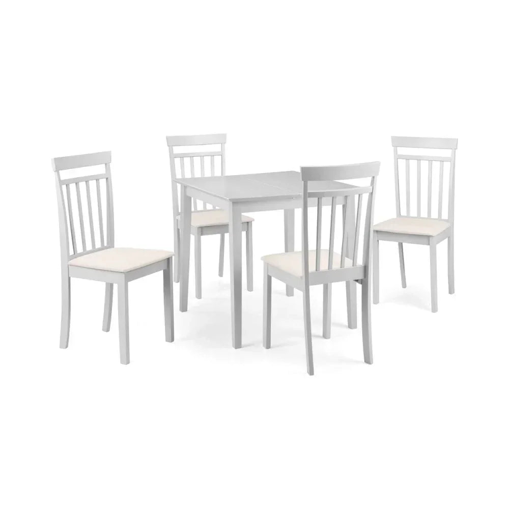 White wooden dining table with four matching chairs featuring cream seat cushions